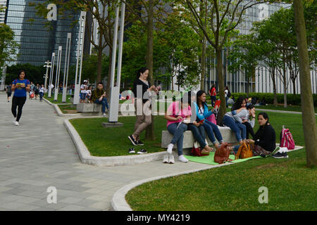 Filipina domestic helpers enjoying their Sunday day off in Tamar park in Hong Kong. Stock Photo