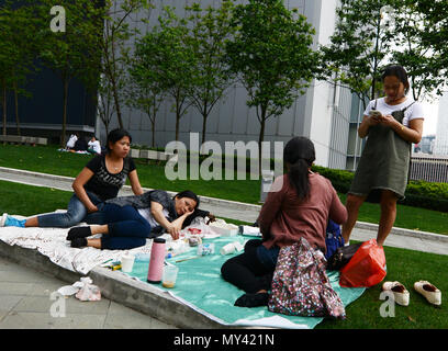 Filipina domestic helpers enjoying their Sunday day off in Tamar park in Hong Kong. Stock Photo