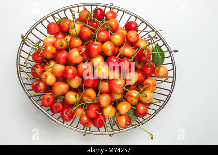 cherries in a metal basket view from above Stock Photo