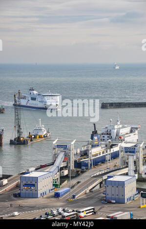 Sea France ferry entering Port of Dover harbour. P&O ferry in dock loading up with lorries, trucks, with others in queue. Portrait. Ferries in Channel Stock Photo