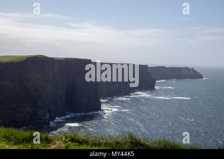 The Cliffs of Moher (Irish: Aillte an Mhothair) are sea cliffs located at the south-western edge of the Burren region in County Clare in Ireland Stock Photo