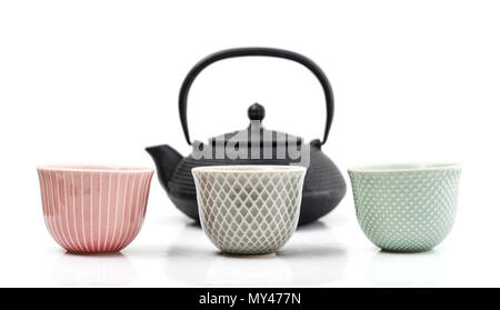 Green tea in cast-iron teapot with small cups isolated on white background Stock Photo
