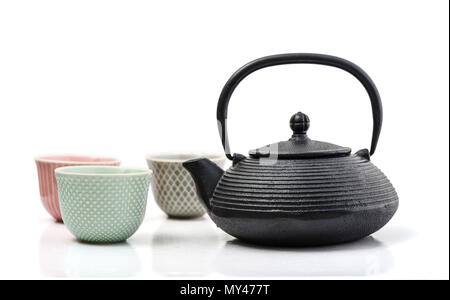 Green tea in cast-iron teapot with small cups isolated on white background Stock Photo