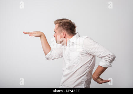 Caucasian excited young man raising his hands in a side view as he dancing. Stock Photo