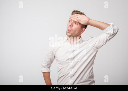 Tired caucasian man in white shirt sweating having fever headache Stock Photo