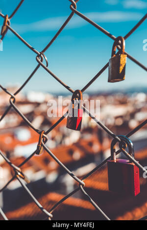 Padlocks on a fence overlooking the rooftops in Lisbon Stock Photo