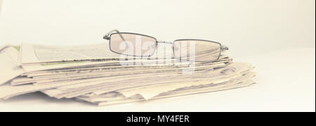 stack of Newspapers and glasses isolated on white Stock Photo