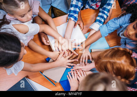 top view of team of adorable kids making team gesture Stock Photo