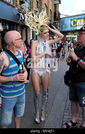 Showgirl being chatted up by men in street, Camden Town, Camden, London, UK Stock Photo