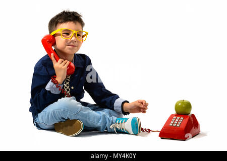 Studio shot of cute boy talking on old telephone Stock Photo