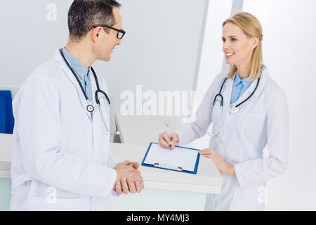 two doctors in white coats discussing diagnosis in hospital Stock Photo