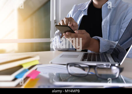 businessman using phone smart phone and notebook computer Stock Photo