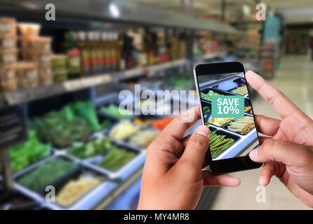 Family in the supermarket use Application of Augmented Reality Supermarket for Discounted or on Sale Stock Photo