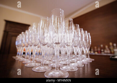 Empty champagne glasses on a wooden bar Stock Photo