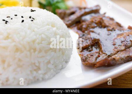 beef fillet with black pepper and rice and cabbage and egg as lunch or dinner Stock Photo