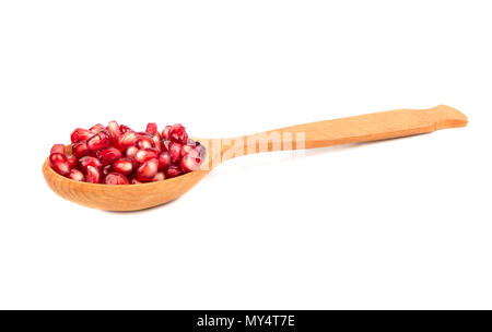 Wooden spoon with pomegranate seeds isolated on white background Stock Photo