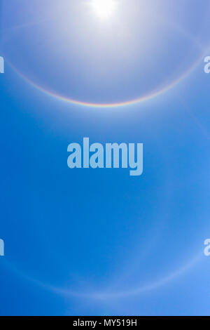 22° halo ring of light 22 degrees from the sun formed by hexagonal ice crystals with additional circumscribed haloes, Comox Valley, British Columbia,  Stock Photo