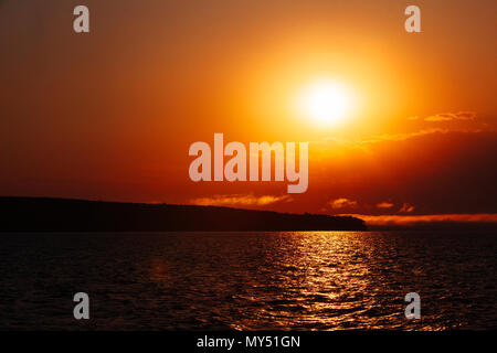 Bright orange sunset over Lake Superior and the Apostle Islands National Lakeshore, Bayfield, Wisconsin, USA Stock Photo