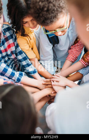 team of adorable kids making team gesture Stock Photo