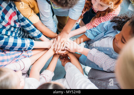 team of adorable kids making team gesture Stock Photo