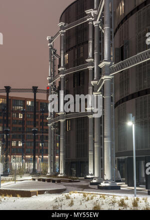 London, England, UK - March 2, 2018: Snow lies on landscaping around the Gasholders, an apartment complex built inside disused Victorian gasometer str Stock Photo