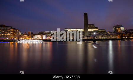 London, England, UK - April 3, 2018: The River Thames flows under Millennium Bridge outside the Tate Modern art gallery and Shakespeare's Globe Theatr Stock Photo