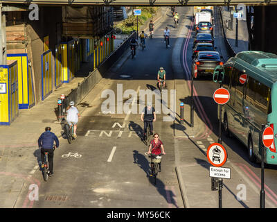 London, England, UK - April 20, 2018: Cyclists ride along CS3, London's east-west Cycle Superhighway, protected from traffic on Upper Thames Street in Stock Photo