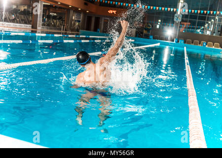back view of winning swimmer gesturing in competition swimming pool Stock  Photo - Alamy