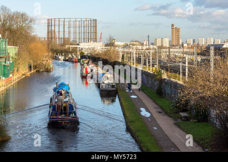 London, England - January 30, 2016: A traditional narrowboat navigating the Grand Union Canal at Old Oak Common, an industrial district and major rede Stock Photo