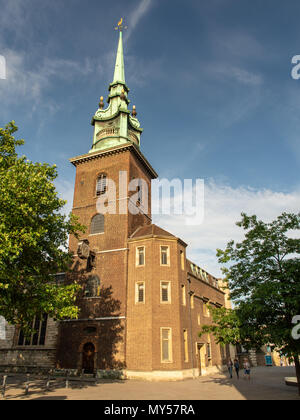 London, England, UK - June 1, 2018: Evening sun lights up the tower and spire of All Hallows by the Tower church in the City of London. Stock Photo