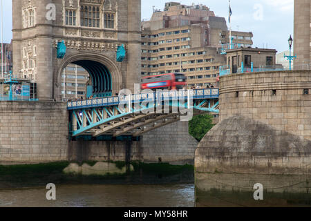 London, England, UK - June 1, 2018: A traditional red double-decker bus crosses London's Tower Bridge. Stock Photo