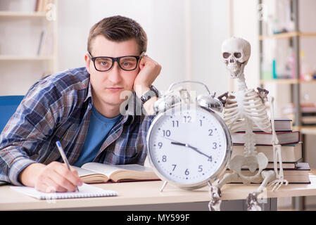 Student and skeleton preparing for school exams Stock Photo