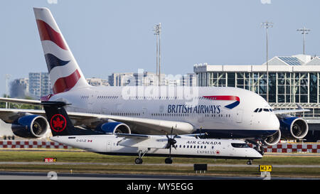 Richmond, British columbia, Canada. 3rd June, 2018. An Air Canada Express Bombardier Dash 8 Q400 regional airliner is dwarfed by a British Airways Airbus A380 superjumbo jet airliner at Vancouver International Airport. The Airbus A380 is the world's largest passenger jet. Credit: Bayne Stanley/ZUMA Wire/Alamy Live News Stock Photo