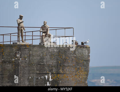 Mulberry Harbours, Portland, UK. 6th Jun, 2018. Unveiling and dedication of six statues on the Mulberry Harbours (also known as Phoenix Caissons) in Portland Harbour, Dorset, representing service people from World War 2, who were actively involved D-Day landings on June 6th, 1944. Credit: Finnbarr Webster/Alamy Live News Credit: Finnbarr Webster/Alamy Live News Stock Photo