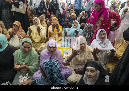 June 6, 2018 - Budgam, Jammu And Kashmir, India - Kashmiri Muslim women devotee prays, at Hazratbal shrine to mark the death anniversary of Imam-e- Ali, the cousin and the son-in-law of the Prophet Muhammad in Srinagar, the summer capital of Indian administered Kashmir, India. Muslims from all over Kashmir visit the Dargah shrine in the Hazratbal area of Srinagar to mark the death anniversary of Caliph, cousin and the son-in-law of the Prophet Muhammad. The shrine is highly revered by Kashmiri Muslims as it is believed to house a holy relic of the Prophet Mohammed. The relic is displayed to th Stock Photo
