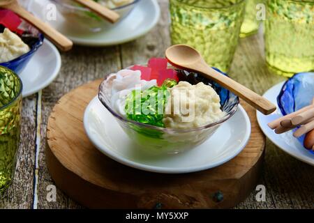 Iced Durian or Es Campur Duren. Cold, icy dessert of crushed ice with durian, jellies, agar agar, and coconut. Stock Photo