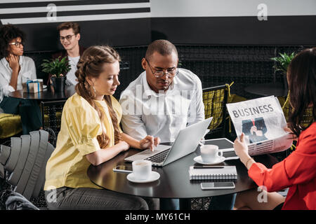 young successful business partners looking at laptop together Stock Photo