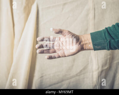 A man with paint on his hand is offering a handshake Stock Photo
