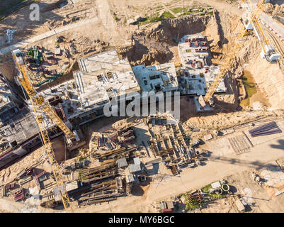 two cranes working on big construction site. aerial view Stock Photo
