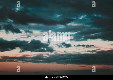 Background of dark clouds before a thunder-storm. Storm clouds in the dark sky. The dark background of bad weather. Stock Photo