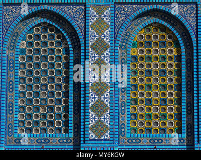 Colorful Islamic patterns, window covered with Arabic  screen, mosaic tiles. Dome of the Rock, Temple Mount mosque, Jerusalem, Israel Stock Photo