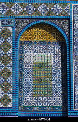 Colorful Islamic patterns, window covered with Arabic  screen, mosaic tiles. Dome of the Rock, Temple Mount mosque, Jerusalem, Israel Stock Photo