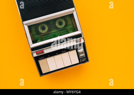 Top view of audio cassette tape player on bright yellow background with copy space, minimalistic retro style composition Stock Photo