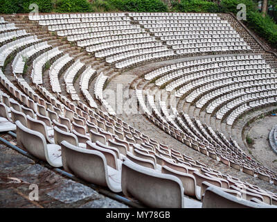 Old Empty White Seats of Rows in Old Outdoor Theater Stock Photo