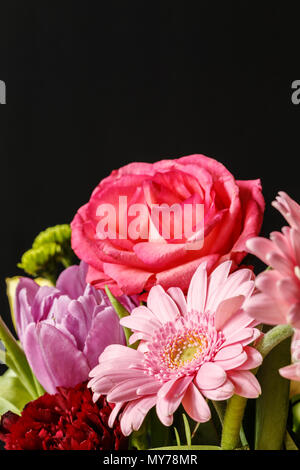 Close-up of red and pink flowers against black background. Valentine's day concept Stock Photo