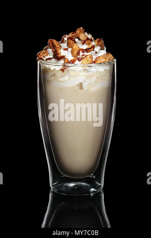 Double walled glass with coffee cocktail decorated with whipped cream and nuts isolated on black Stock Photo