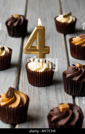 Number 4 celebration birthday cupcakes on a wooden background Stock Photo
