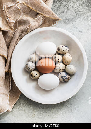 Variety of birds eggs in a bowl, overhead view Stock Photo