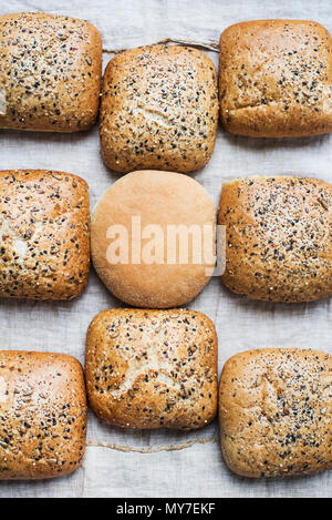 Multigrain bread rolls and white bread roll, overhead view Stock Photo