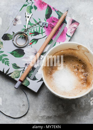 Cup of coffee with notebook and pencil, overhead view Stock Photo